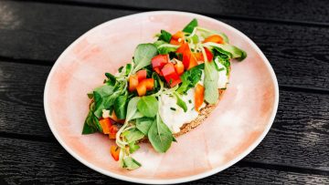 Delicious open-faced sandwich with fresh vegetables on whole grain bread, perfect for a healthy meal.